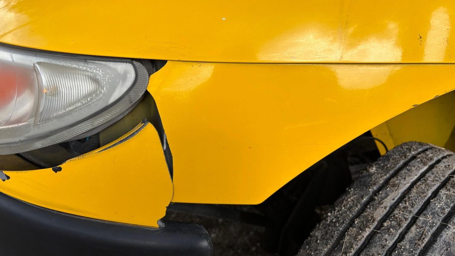 minor frontal bumper dent repair in a yellow car