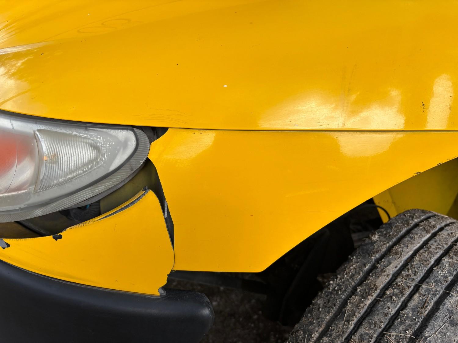 minor frontal bumper dent repair in a yellow car
