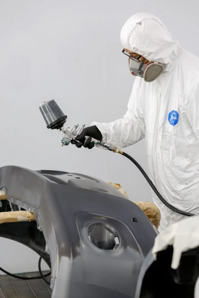 auto painting a bumper of a car