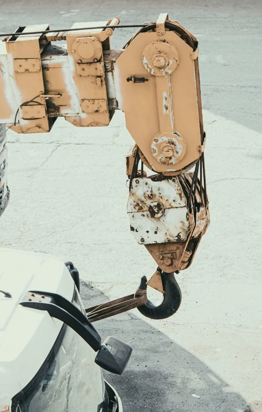 Close-up view of an industrial crane hook attached to a truck