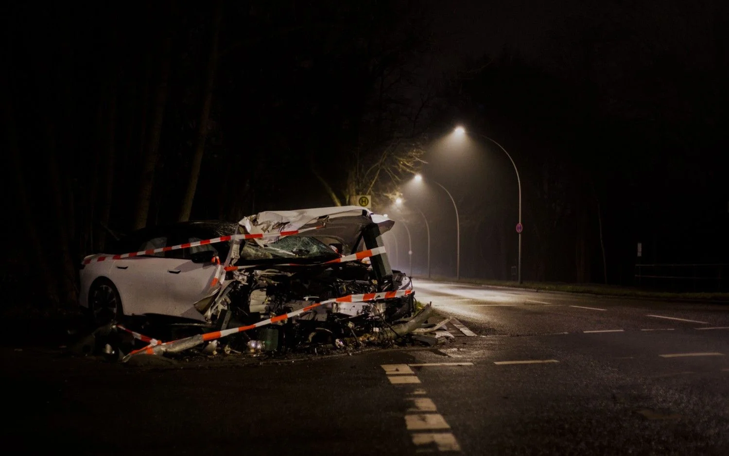 A wrecked car after a crash on a dimly lit street in san diego at night.
