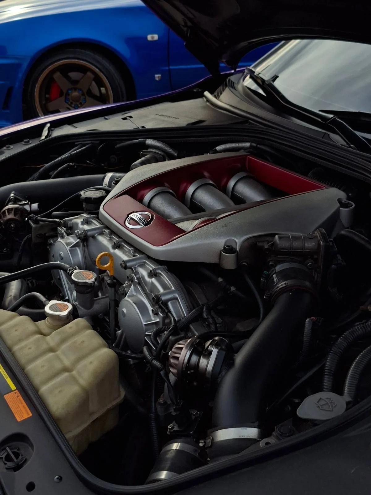 Close-up of a high-performance Nissan car engine, emphasizing automotive engineering excellence.