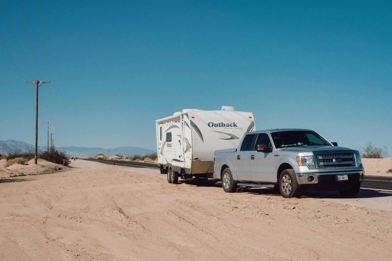 tow truck transferring a damaged rv